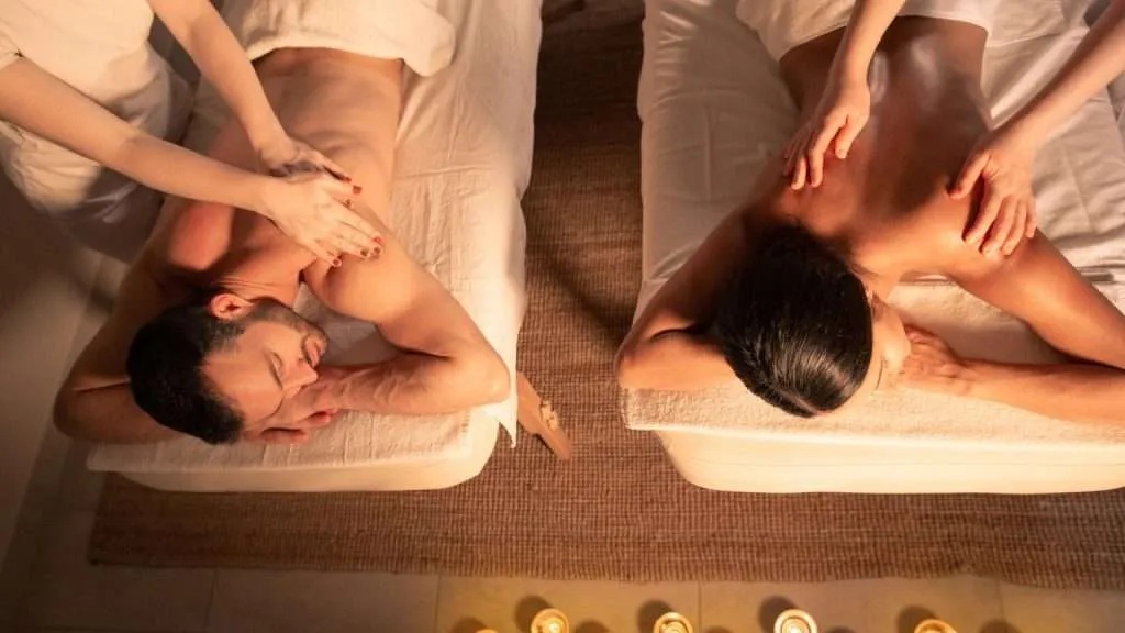 Thai woman therapist stretching a client's shoulder and arm